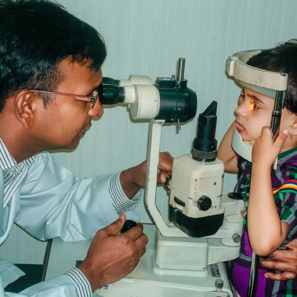 Pediatric ophthalmologist examining a child's eyes with a slit lamp at Utsav Eye Clinic